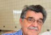 Morre em Ponta Porã o jornalista João Natalício de Oliveira, referência da imprensa na fronteira Retrato do jornalista João Natalício de Oliveira, de Ponta Porã, com óculos e camisa azul xadrez; imagem aprimorada digitalmente